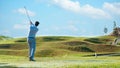 Golfer sport course golf ball fairway.ÃÂ  People lifestyle man playing game and swing golf tee off on the green grass.ÃÂ  Royalty Free Stock Photo